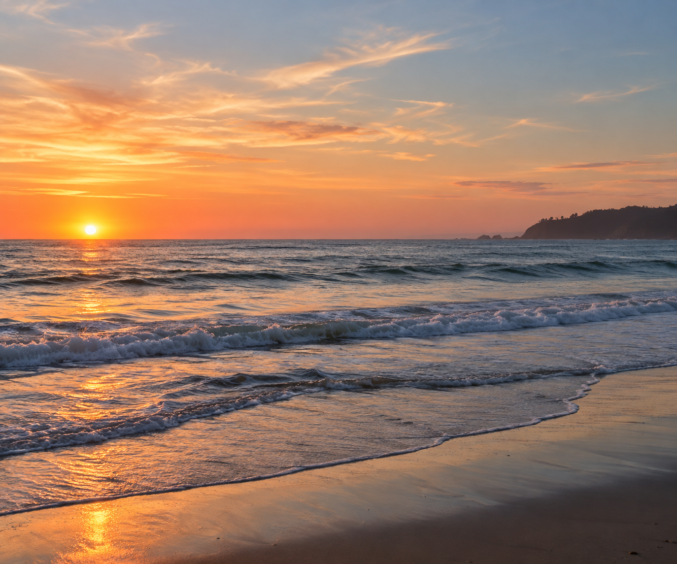 Gentle waves meeting the shore at sunset.